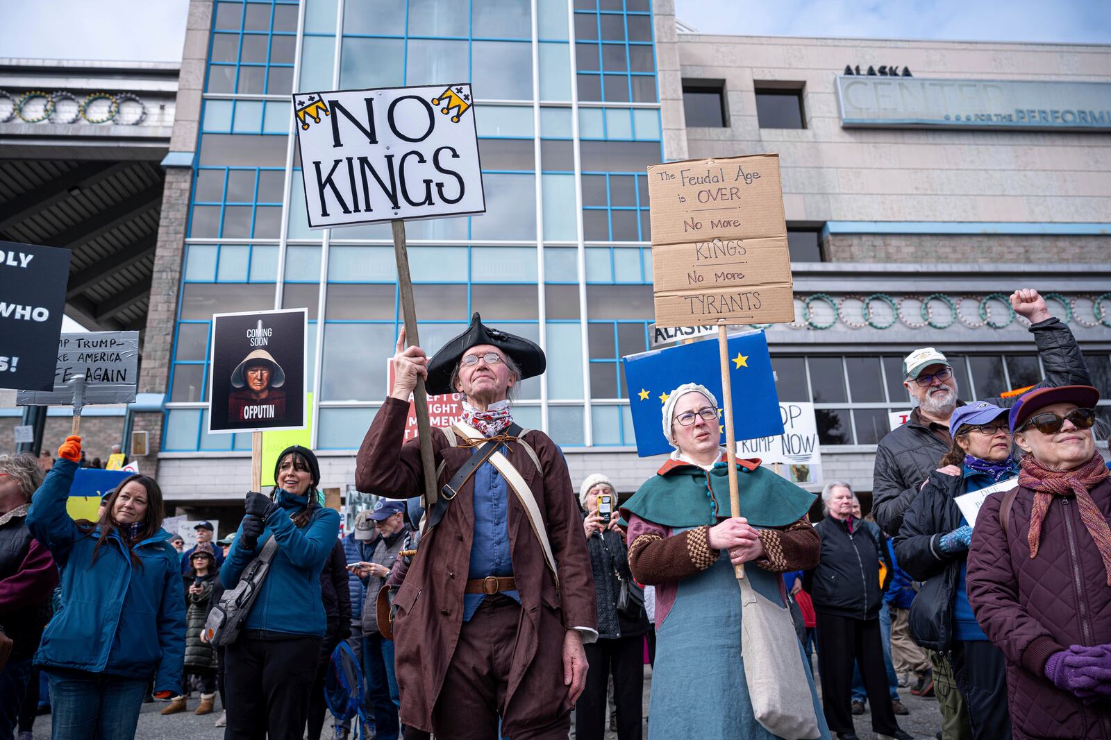 David Teague, a colonial reenactor, holds a sign that says "No Kings" during a protest against President Trump and his policies on Saturday, April 19, 2025 in Anchorage, Alaska. (Loren Holmes/Anchorage Daily News via AP)