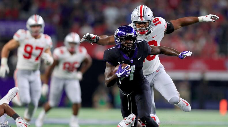 ARLINGTON, TX - SEPTEMBER 15: Jalen Reagor #1 of the TCU Horned Frogs carries the ball against Damon Arnette Jr #3 of the Ohio State Buckeyes and Jonathon Cooper #18 of the Ohio State Buckeyes in the first quarter during The AdvoCare Showdown at AT&T Stadium on September 15, 2018 in Arlington, Texas. (Photo by Tom Pennington/Getty Images)