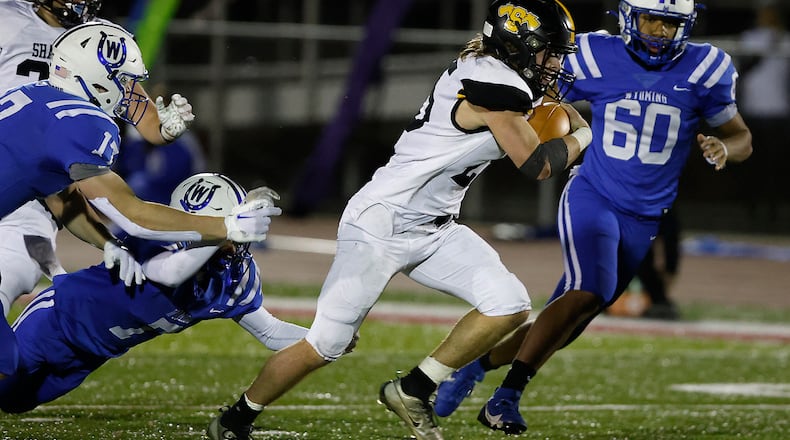 TJ Meeks breaks through the Wyoming defense and runs for a touchdown during Friday's playoff game. BILL LACKEY/STAFF
