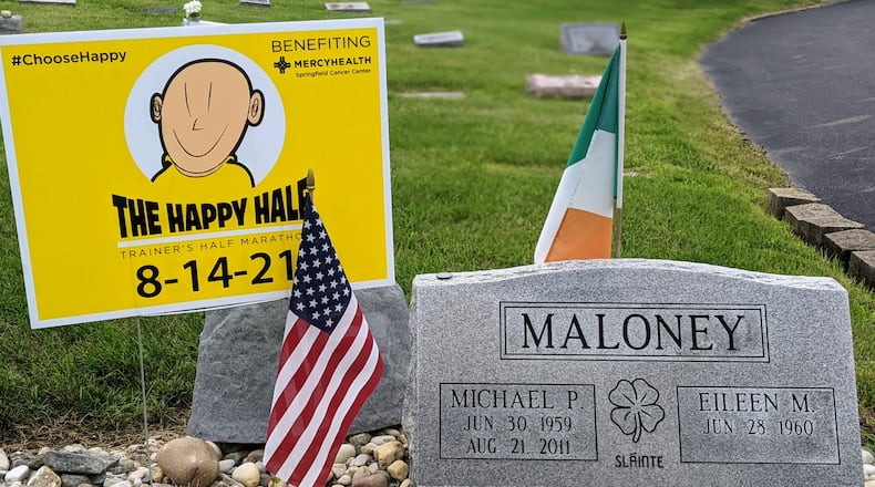 A Happy Half Marathon sign stands in Saint Bernard Cemetery next to the grave of Mike Maloney, whose battle with cancer inspired the race in Springfield. Photo by Eileen Maloney