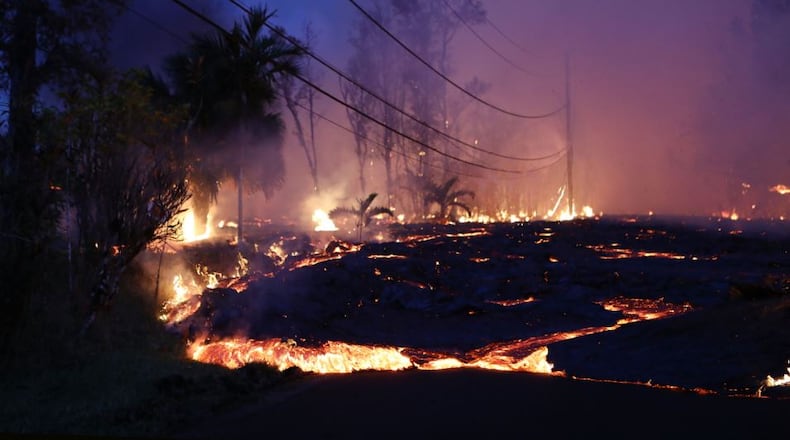 Lava from a Kilauea volcano fissure advances up a residential street in Leilani Estates, on Hawaii’s Big Island, on May 27 in Pahoa, Hawaii. Mario Tama/Getty Images
