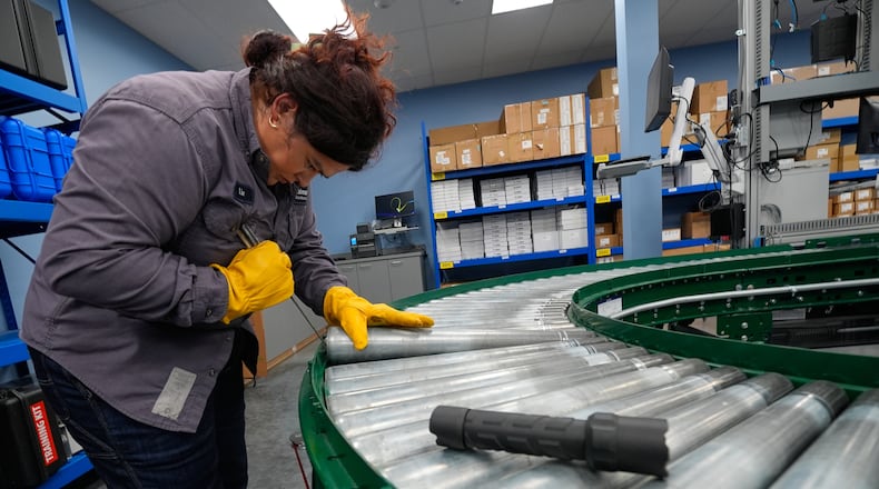 Maintenance technician Liz Cardenas replaces a conveyor belt roller at a training area in a Walmart distribution center Thursday, Sept. 25, 2025, in Bentonville, Ark. (AP Photo/Charlie Riedel)