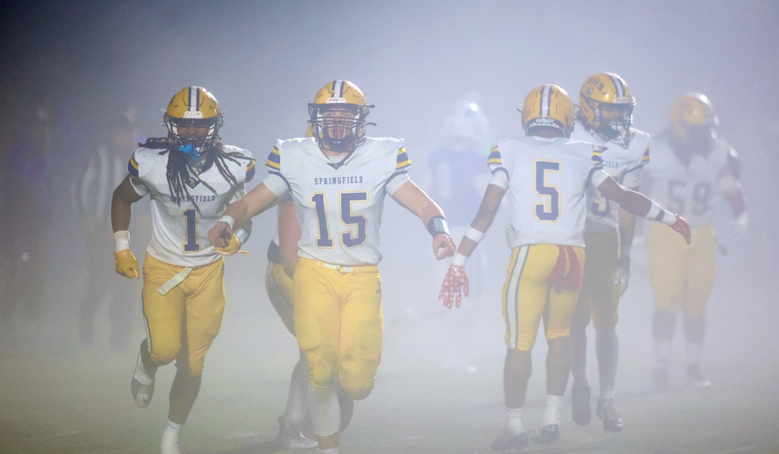 Springfield players, including Carter Bumgardner (15), celebrate a defensive stop against Springboro in the second round of the Division I, Region 2 playoffs on Friday, Nov. 7, 2025, at CareFlight Field in Springboro. David Jablonski/Staff