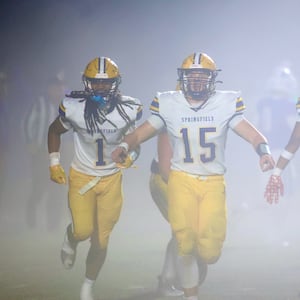 Springfield players, including Carter Bumgardner (15), celebrate a defensive stop against Springboro in the second round of the Division I, Region 2 playoffs on Friday, Nov. 7, 2025, at CareFlight Field in Springboro. David Jablonski/Staff