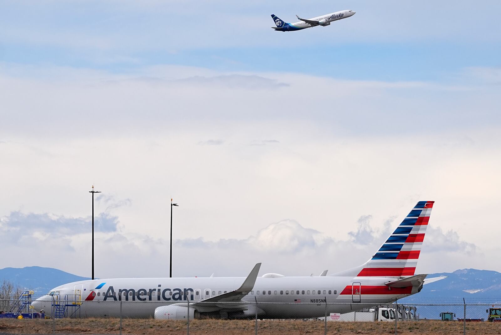 FILE - An American Airlines jetliner that caught fire after landing the previous day at Denver International Airport sits near a hangar at the airport, March 14, 2025, in Denver. (AP Photo/David Zalubowski, File)