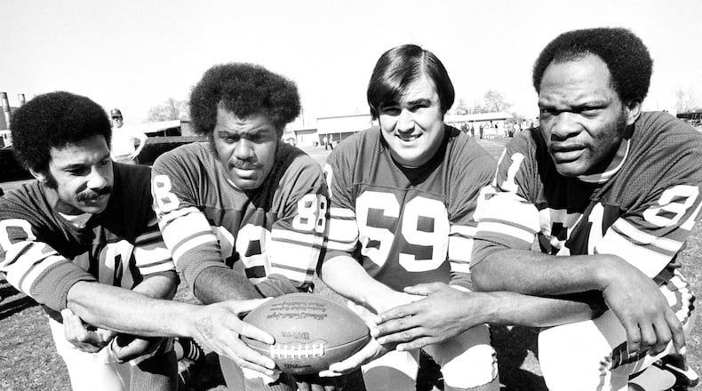 FILE - Minnesota Vikings defensemen Jim Marshall, Alan Page, Doug Sutherland and Carl Eller, from left, pose for a photo in January 1975. Sutherland, a member of the Purple People Eaters, has died. He was 73. The team released a statement Tuesday, April 5, 2022, without providing a cause. AP Photo/File)