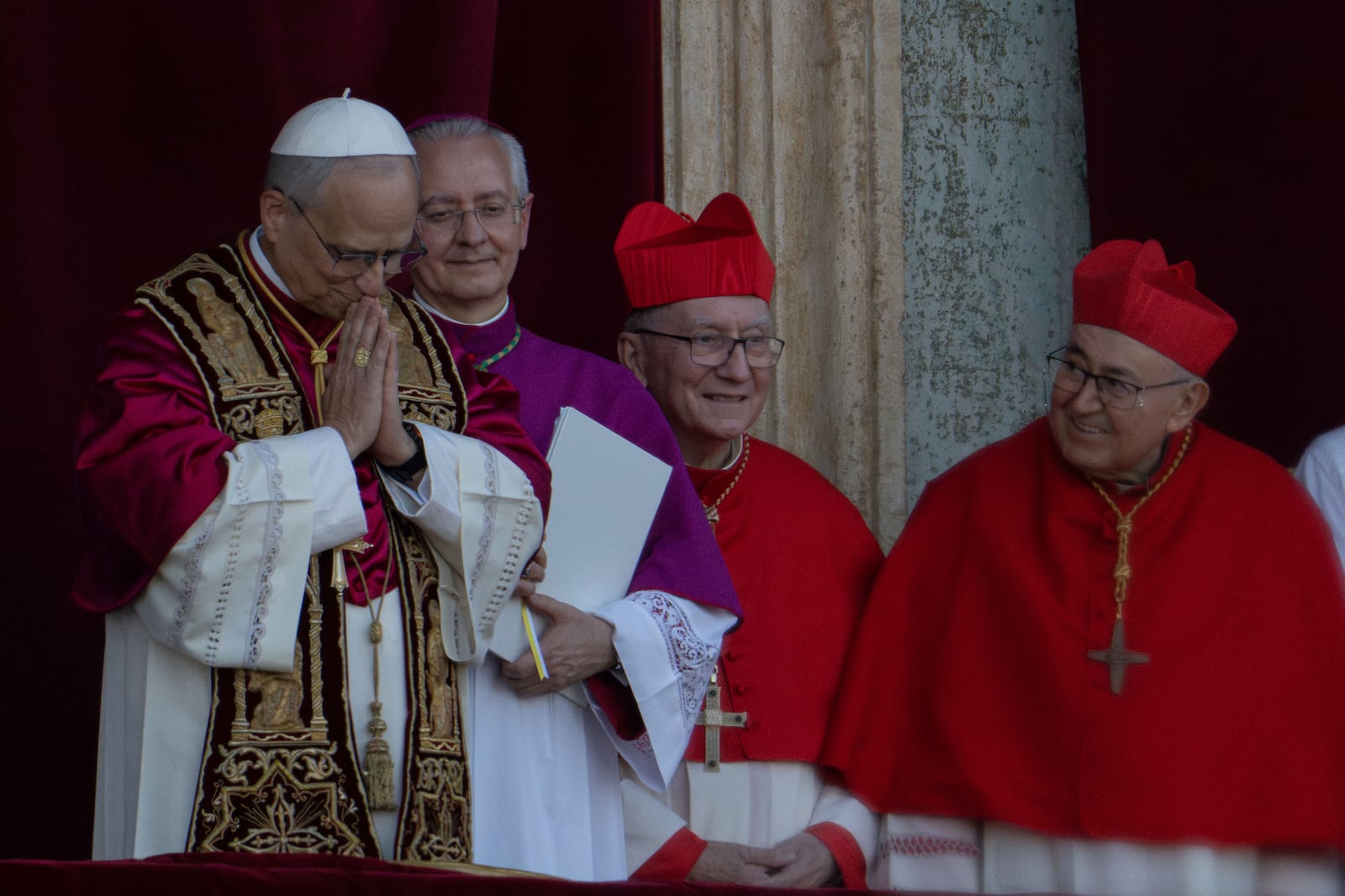 Newly elected Pope Leo XIV, left, formerly Cardinal Robert Francis Prevost, appears with, from left, Master of Ceremonies Archbishop Diego Giovanni Ravelli, Cardinal Pietro Parolin, and Cardinal Vinko Puljić on the central loggia of St. Peter's Basilica at the Vatican shortly after his election as the 267th pontiff of the Roman Catholic Church, Thursday, May 8, 2025. (AP Photo/Domenico Stinellis)