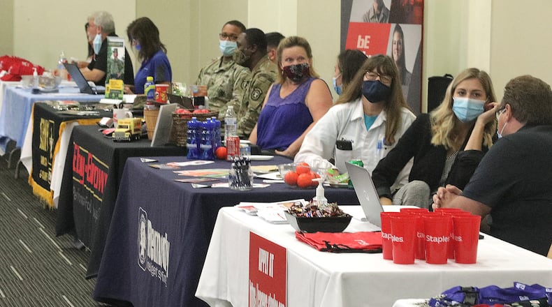 Employers wait for people at the 10th Annual Clark County Career Fair Wednesday. BILL LACKEY/STAFF