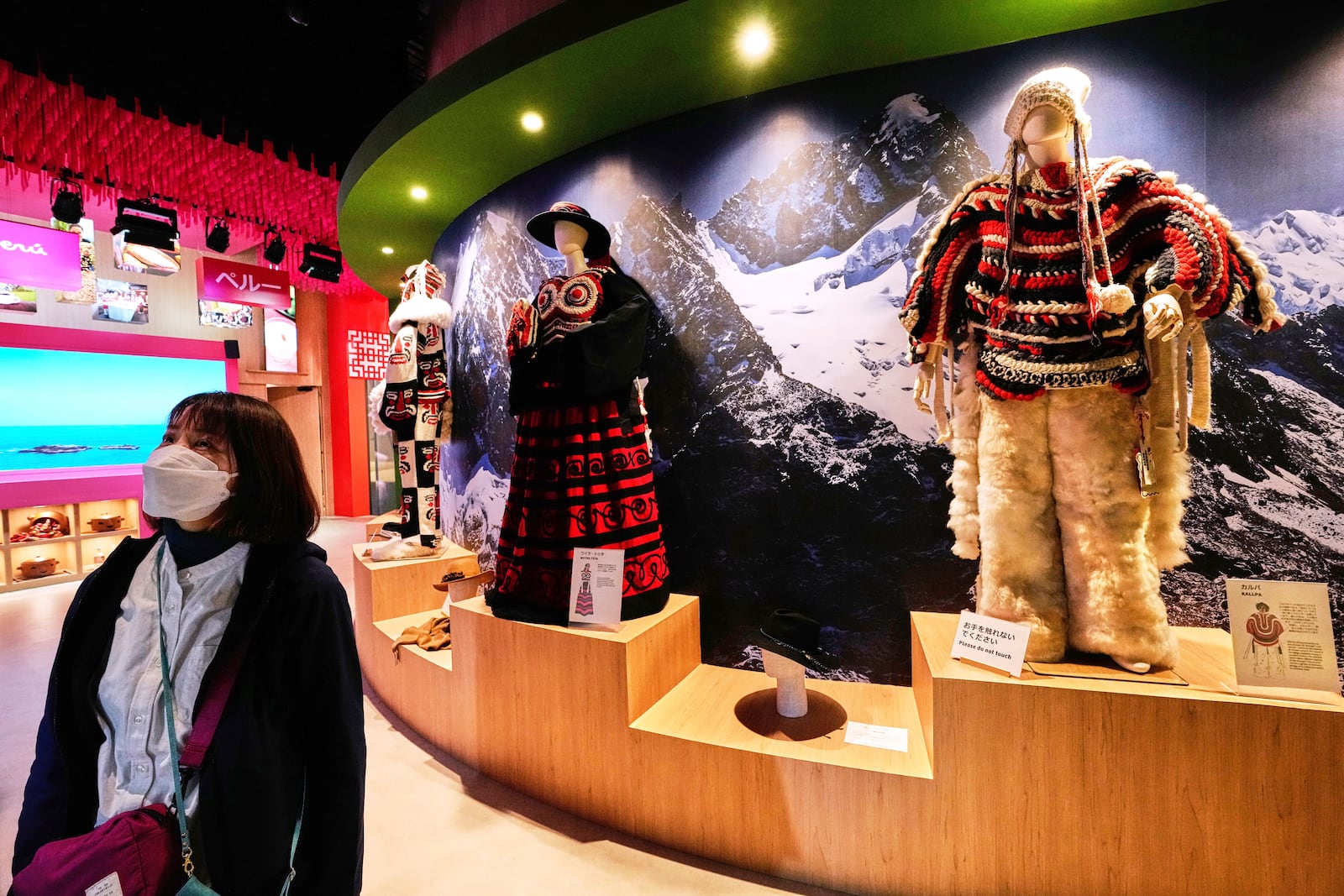 A woman looks at displays at Peru's pavilion during the Expo 2025 in Osaka, western Japan, Tuesday, April 15, 2025. (AP Photo/Hiro Komae)
