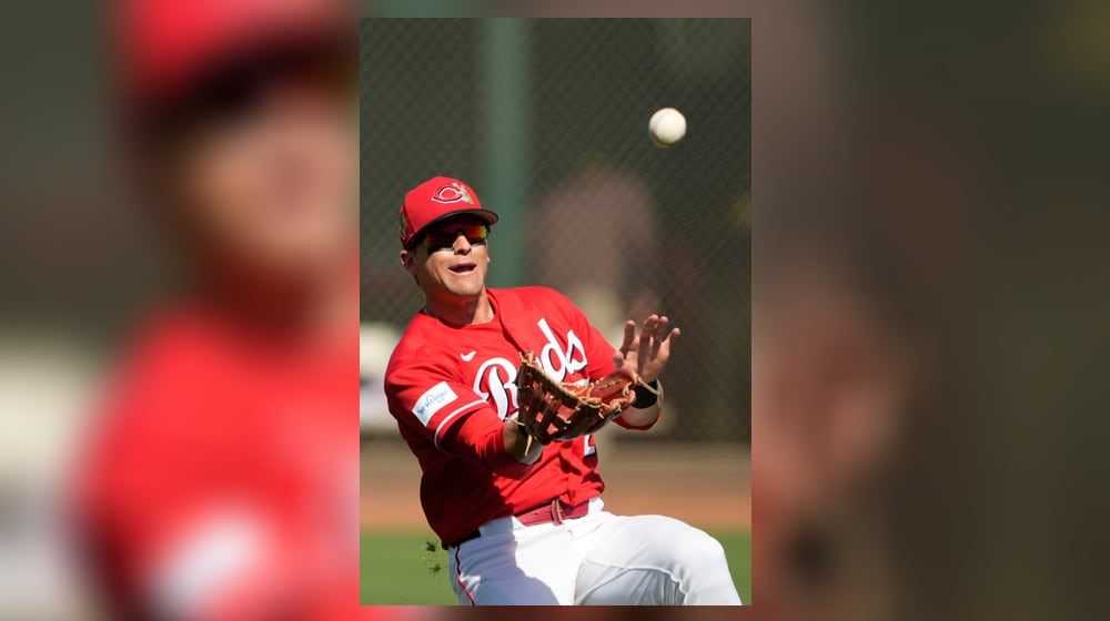Cincinnati Reds left fielder TJ Friedl catches a fly ball by center fielder Bryce Johnson during the first inning of a spring baseball game in Goodyear, Ariz., Thursday, Feb. 26, 2026. (AP Photo/Chris Carlson)
