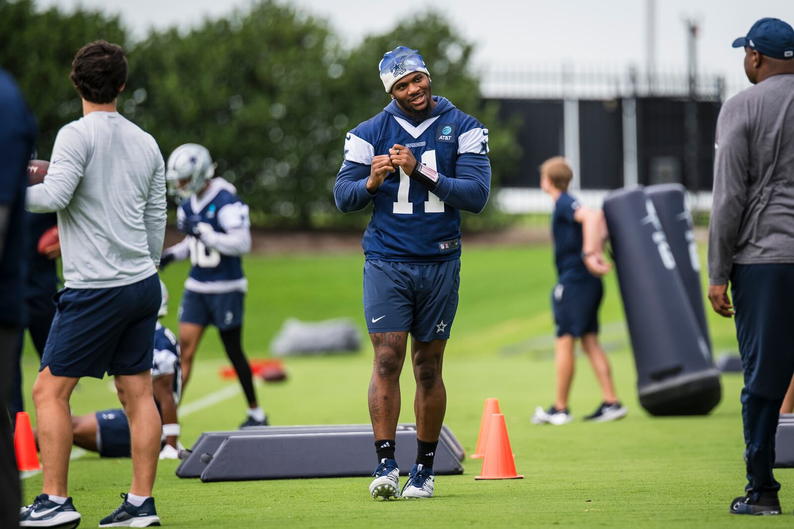Dallas Cowboys' Micah Parsons talks to a coach during NFL football practice at the Cowboys facility, Tuesday, June 10, 2025, in Frisco, Texas. (AP Photo/Jessica Tobias)