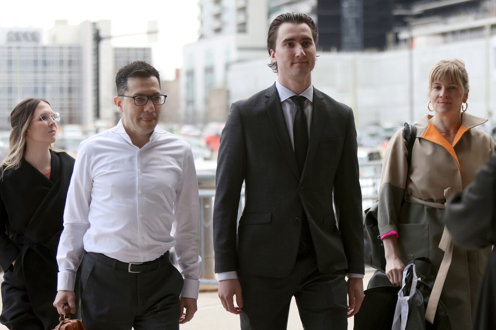 Alex Formenton, second from right, one of five members of Canada’s 2018 world junior hockey team charged with sexual assault last year for an incident that allegedly took place in June 2018, arrives at the London Courthouse in London, Ontario, Wednesday, April 23, 2025. (Nicole Osborne/The Canadian Press via AP)