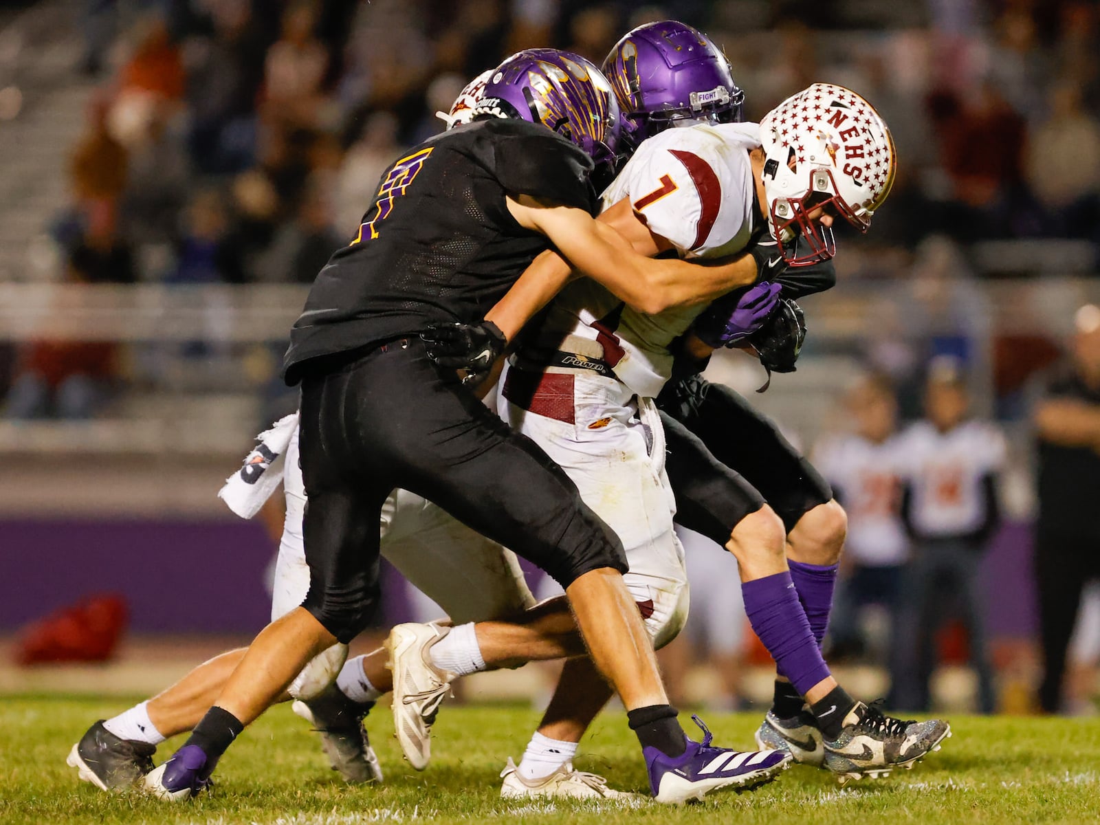Northeastern High School senior Jackson Jones is tackled by two Mechaniscburg defenders during their 52-36 win over Indians on Friday, Oct. 17 at Indian Stadium. MICHAEL COOPER / STAFF