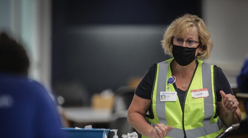 FILE PHOTO Premier Health Nurse Midwife, Susan Kloth prepares COVID-19 vaccines at the University of Dayton Arena.