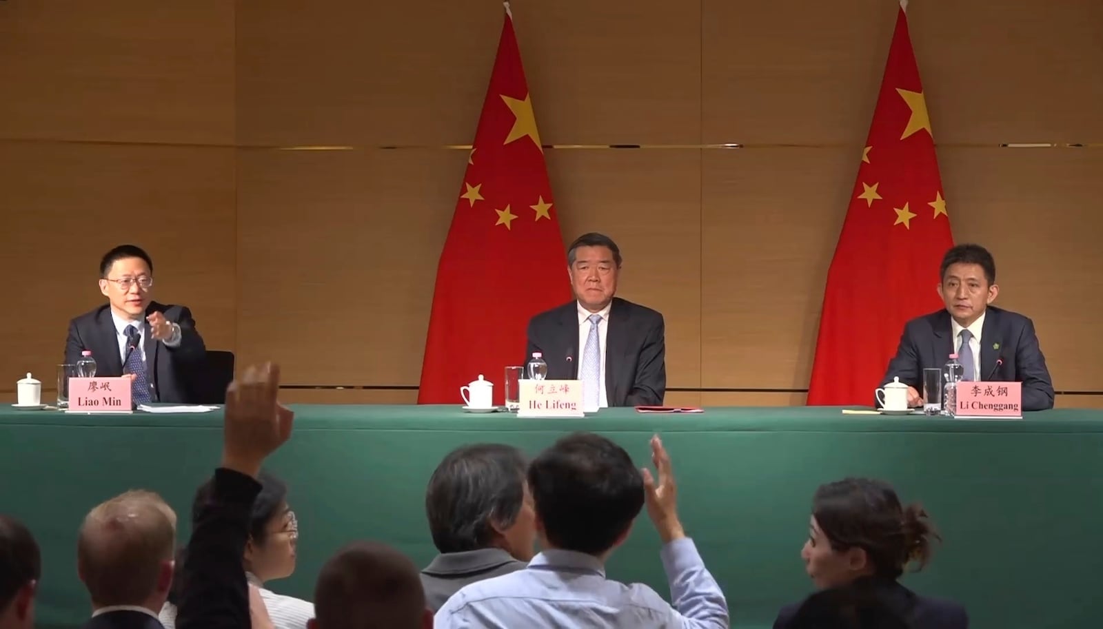 Vice minister of Finance Liao Min, left, gestures toward a journalist at a news conference at the Chinese mission to the World Trade Organization in Geneva, Switzerland, Sunday, May 11, 2025, alongside Vice Premier He Lifeng and Li Chenggang, vice minister of commerce. (AP Photo/Jamey Keaten)