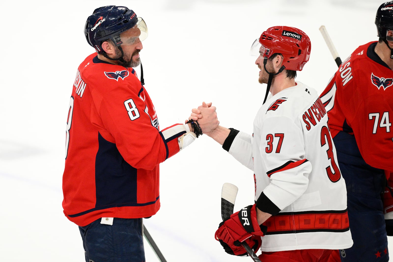 Washington Capitals left wing Alex Ovechkin, left, and Carolina Hurricanes right wing Andrei Svechnikov, right, greet each other after Game 5 of a second-round NHL hockey playoff series Thursday, May 15, 2025, in Washington. (AP Photo/Nick Wass)