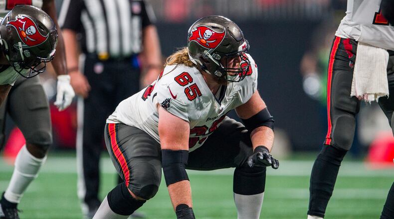 FILE - Tampa Bay Buccaneers guard Alex Cappa (65) lines up during the second half of an NFL football game against the Atlanta Falcons, Sunday, Dec. 5, 2021, in Atlanta. Cappa has agreed to a free agent contract with the Cincinnati Bengals. (AP Photo/Danny Karnik, File)