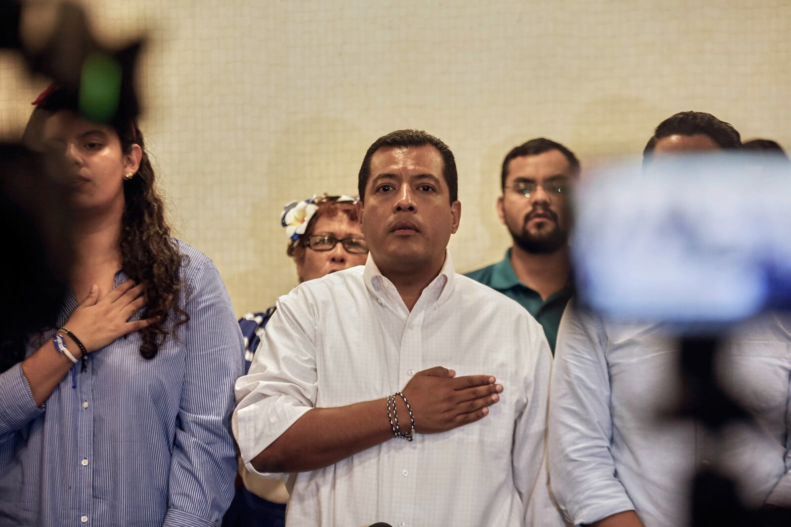 FILE - Nicaraguan opposition activist Felix Maradiaga stands at attention as the national anthem is sung during a news conference in Managua, Nicaragua, Sept. 18, 2019. (AP Photo/Alfredo Zuniga, File)