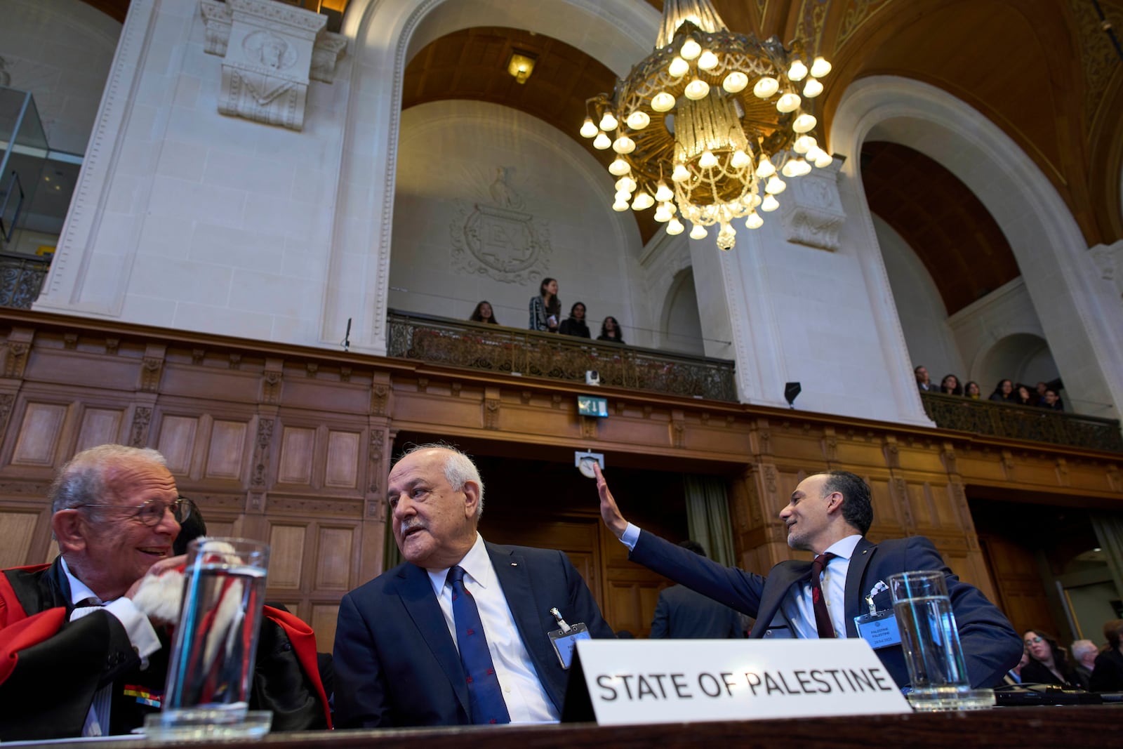 Palestinian Ambassador to the United Nations Riyad Mansour, center, and other members of the legal team wait for the International Court of Justice to open hearings into a United Nations request for an advisory opinion on Israel's obligations to allow humanitarian assistance in Gaza and the West Bank, in The Hague, Netherlands, Monday, April 28, 2025. (AP Photo/Peter Dejong)