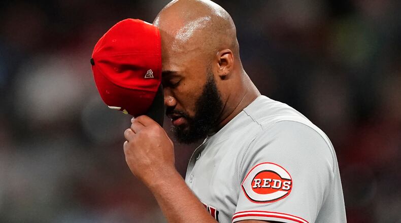Cincinnati Reds relief pitcher Amir Garrett takes a moment before working in relief during the sixth inning of the team's baseball game against the Atlanta Braves on Tuesday, Aug. 10, 2021, in Atlanta. (AP Photo/John Bazemore)