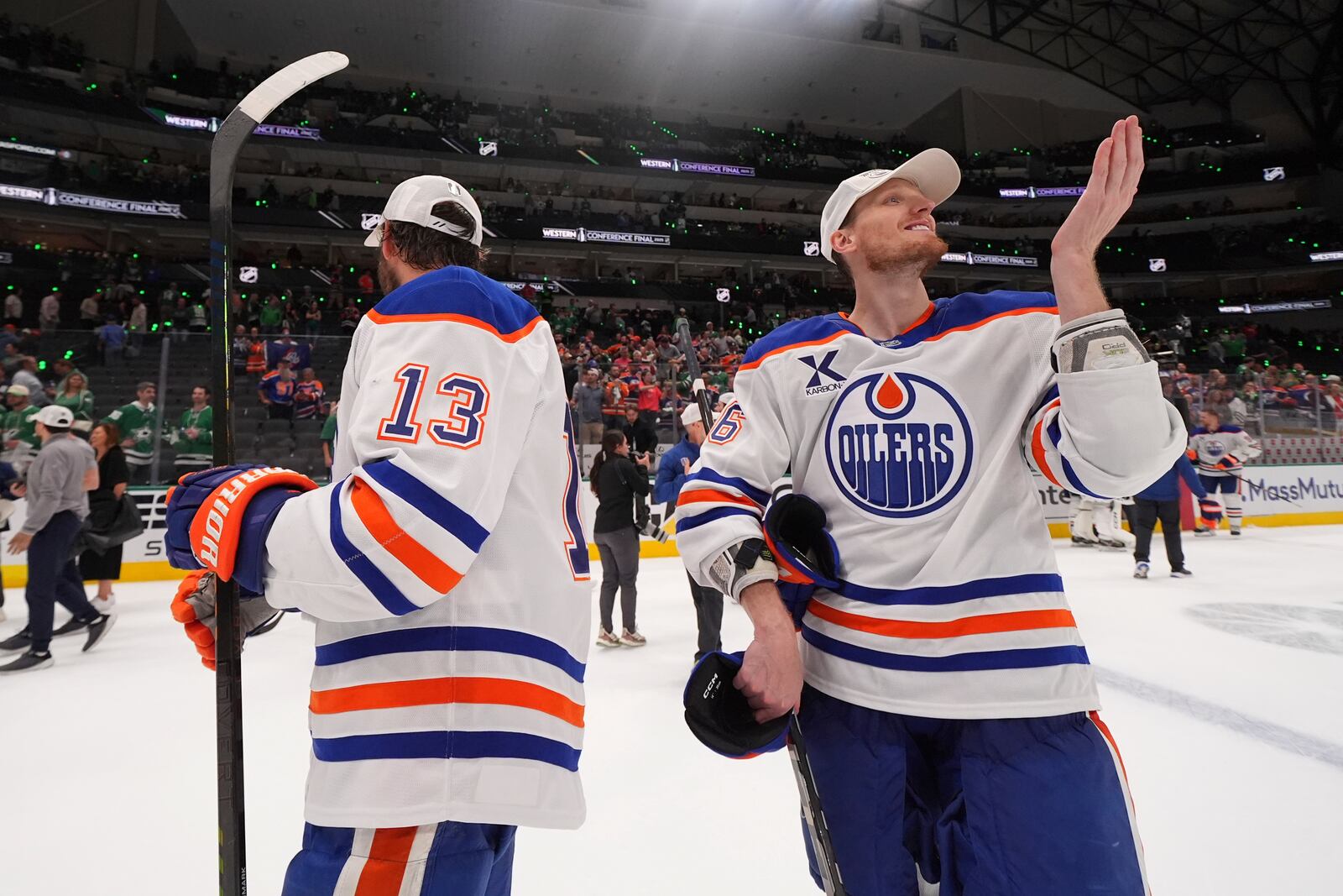 Edmonton Oilers center Mattias Janmark (13) and defenseman John Klingberg (36) celebrate after winning Game 5 of the Western Conference finals against the Dallas Stars in the NHL hockey Stanley Cup playoffs, Thursday, May 29, 2025, in Dallas. (AP Photo/Julio Cortez)