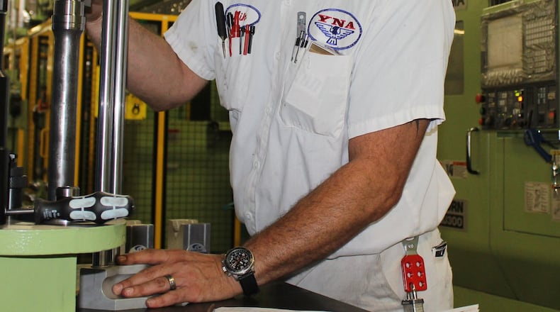 Yamada North America employee Mike Lohmann performs a quality check on a half shaft at the plant in South Charleston. Yamada North America hopes to hire 40 employees in the near future. Jeff Guerini/staff