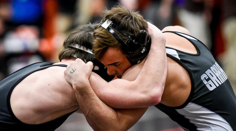 Graham’s Mitch Moore gets the win over Badin’s Kane Schmidt during their match in the 132 pound weight class at Division II district wrestling tournament Friday at Wilmington High School. NICK GRAHAM/STAFF
