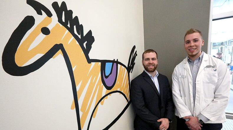 Andrew Straw, Assistant Professor of Pharmacy Practice at Cedarville University and Residency Program Director, and Josh Willoughby, Pharmacy Resident from Cedarville at the Rocking Horse Center. Bill Lackey/Staff