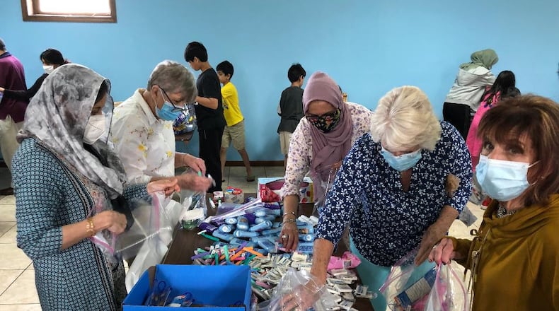 Members of the Christian and Muslim faiths teamed up to pack 400 bags of food and hygiene items at theMasjid Al-Madina Mosque on Sunday to support the Springfield Soup Kitchen.