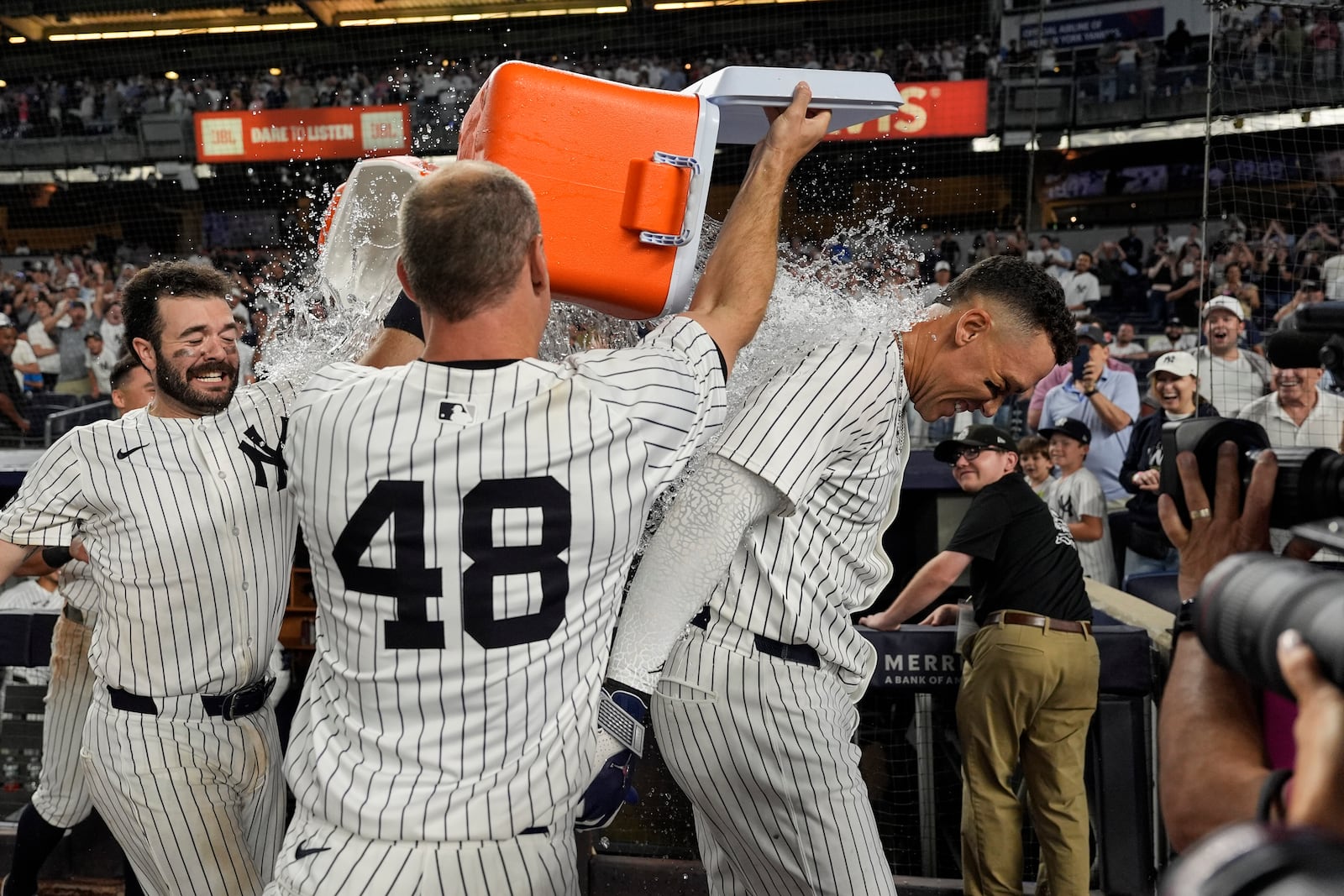 New York Yankees players throw Gatorade on designated hitter Aaron Judge after winning a baseball game against the Seattle Mariners, Thursday, July 10, 2025, in New York. (AP Photo/Yuki Iwamura)