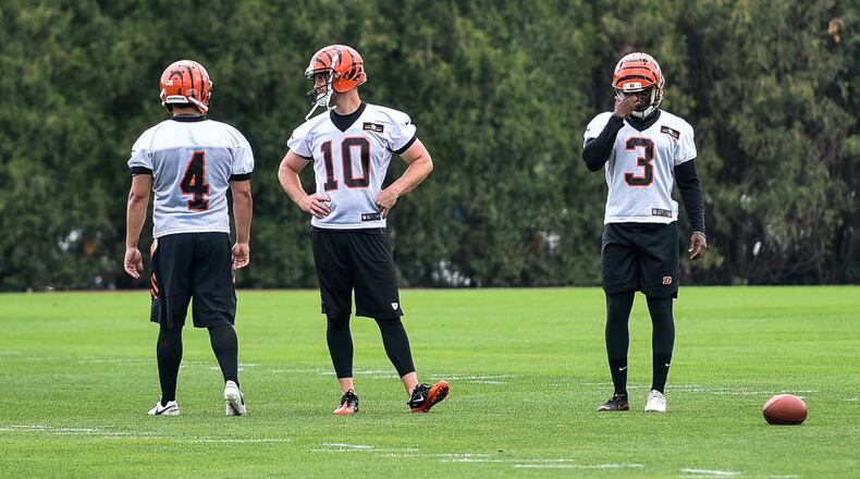 Bengals’ kickers Randy Bullock (4), Kevin Huber (10) and Jonathan Brown (3) prepare for kicking drills during organized team activities Tuesday, May 22 at the practice facility near Paul Brown Stadium in Cincinnati. NICK GRAHAM/STAFF