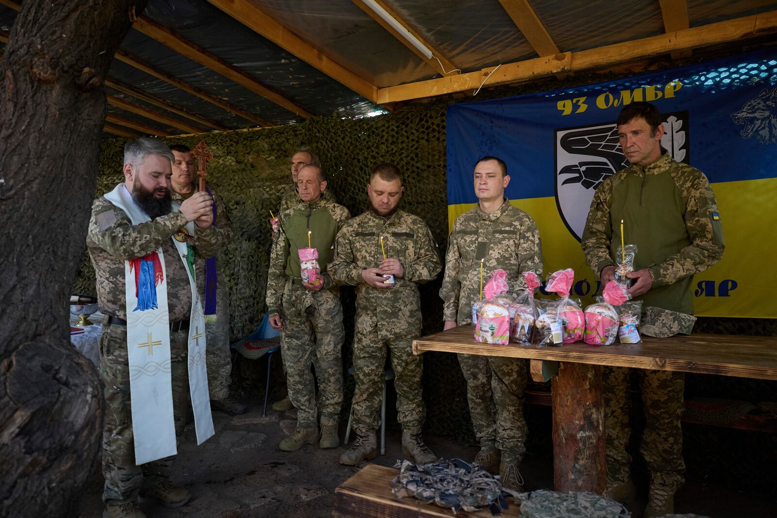 In this photo provided by Ukraine's 93rd Kholodnyi Yar Separate Mechanized Brigade press service, Ukrainian servicemen attend an Easter service on their position in the Donetsk region, Ukraine, Sunday, April 20, 2025. (Mykola Oliinyk/Ukraine's 93rd Mechanized Brigade via AP)