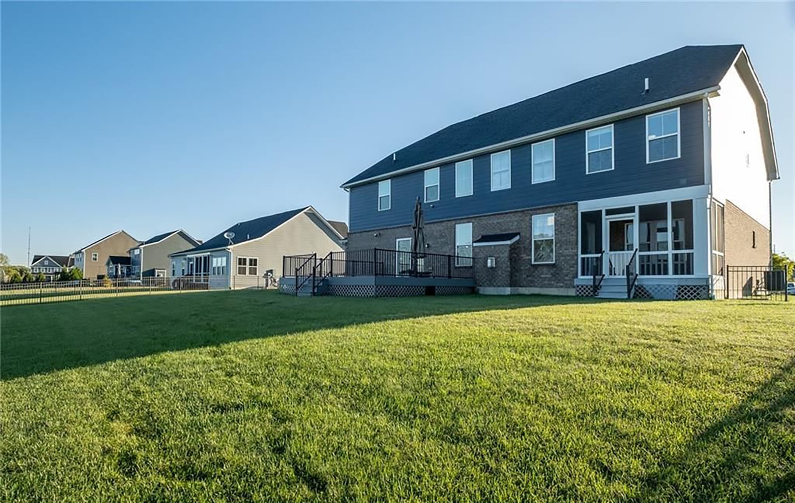 The back yard is fully fenced and has views of the lake and fountain. The home has a screened in porch and composite deck with metal railings. CONTRIBUTED