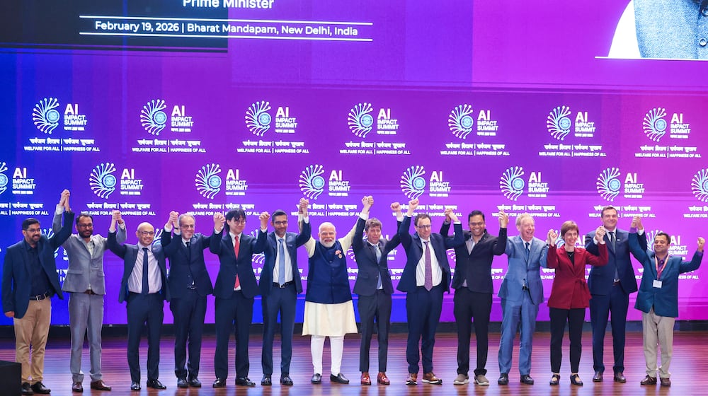 India's Prime Minister Narendra Modi, seventh left, poses for photographs with chief executive officers of various AI groups during the AI Summit in New Delhi, India, Thursday, Feb. 19, 2026. (Indian Prime Minister's Office via AP)