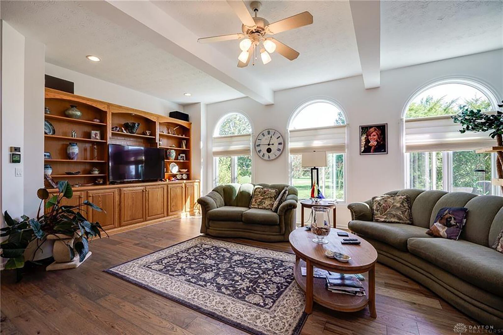 The living room has hardwood flooring, a gas fireplace and built in bookcases.