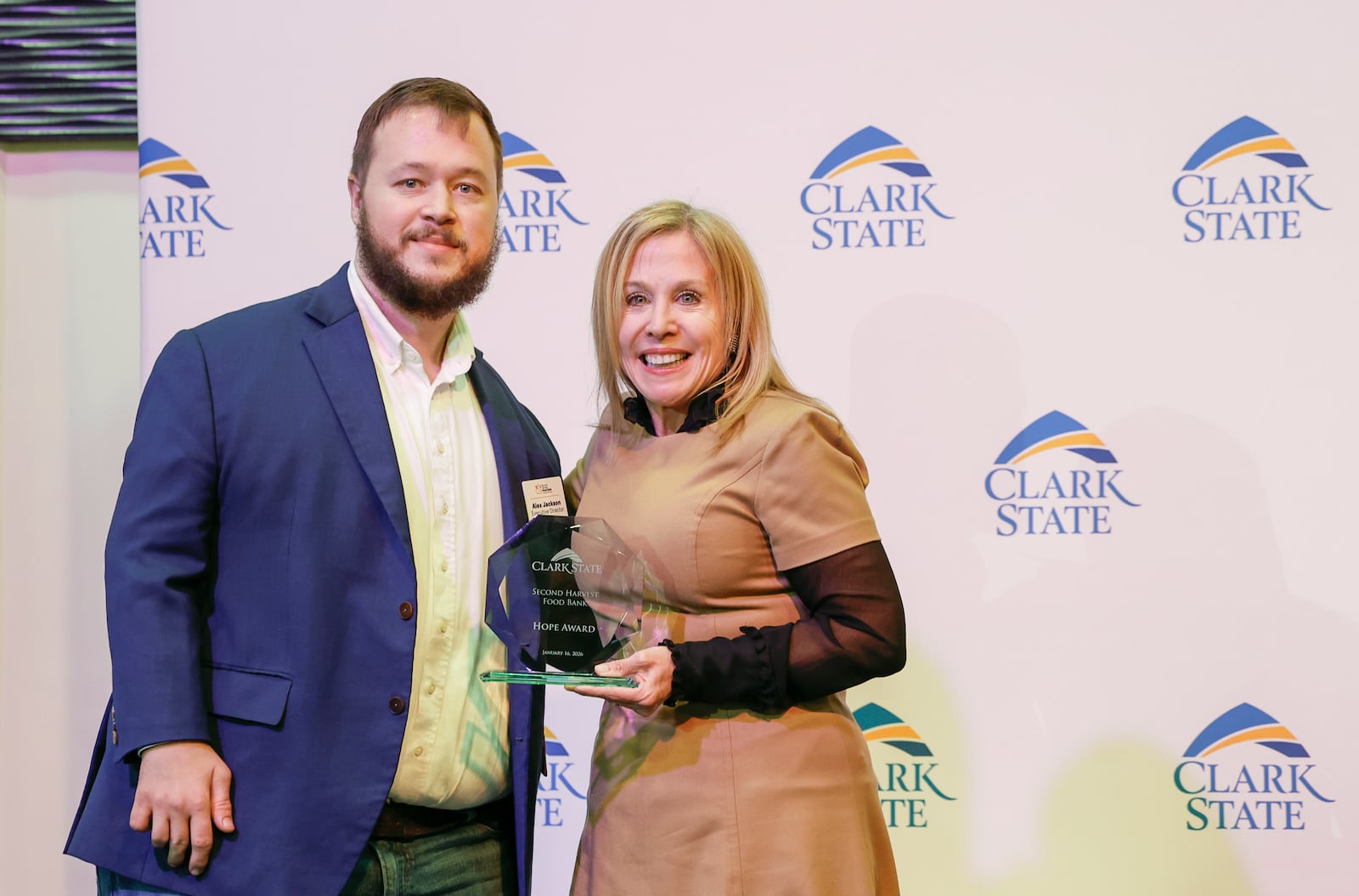 Alex Jackson, executive director at Second Harvest Food Bank, receives the Presentation of Hope Award from Clark State President Jo Alice Blondin at Clark State College's annual MLK luncheon and awards ceremony at the Hollenbeck Bayley Center on Friday, Jan. 16, 2026, in Springfield. JOSEPH COOKE/STAFF