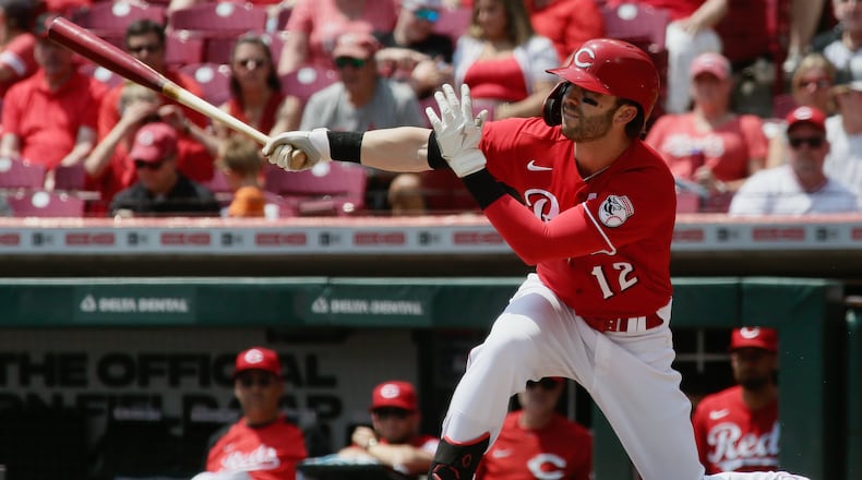 Tyler Naquin, of the Reds, triples with the bases loaded in the first inning against the Brewers on Wednesday, May 11, 2022, at Great American Ball Park in Cincinnati. David Jablonski/Staff
