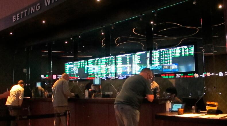 FILE - People line up to make sports bets at the Borgata casino in Atlantic City, N.J., March 19, 2021. Sports betting becomes legal in the state of Ohio on Jan. 1. (AP Photo/Wayne Parry, File)