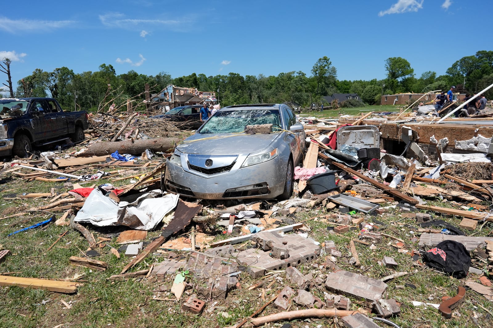 Debris covers the ground and damaged vehicles after a severe storm passed the area on Saturday, May 17, 2025 in London, Ky. (AP Photo/Carolyn Kaster)