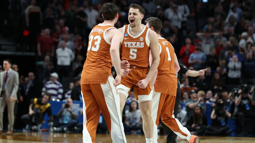 Texas forward Camden Heide (5) celebrates with teammates after the second round of the NCAA college basketball tournament against the Gonzaga, Saturday, March 21, 2026, in Portland, Ore. (AP Photo/Amanda Loman)