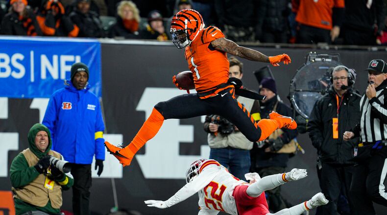 Cincinnati Bengals wide receiver Ja'Marr Chase (1) leaps over Kansas City Chiefs safety Juan Thornhill (22) in the first half of an NFL football game in Cincinnati, Sunday, Dec. 4, 2022. (AP Photo/Jeff Dean)