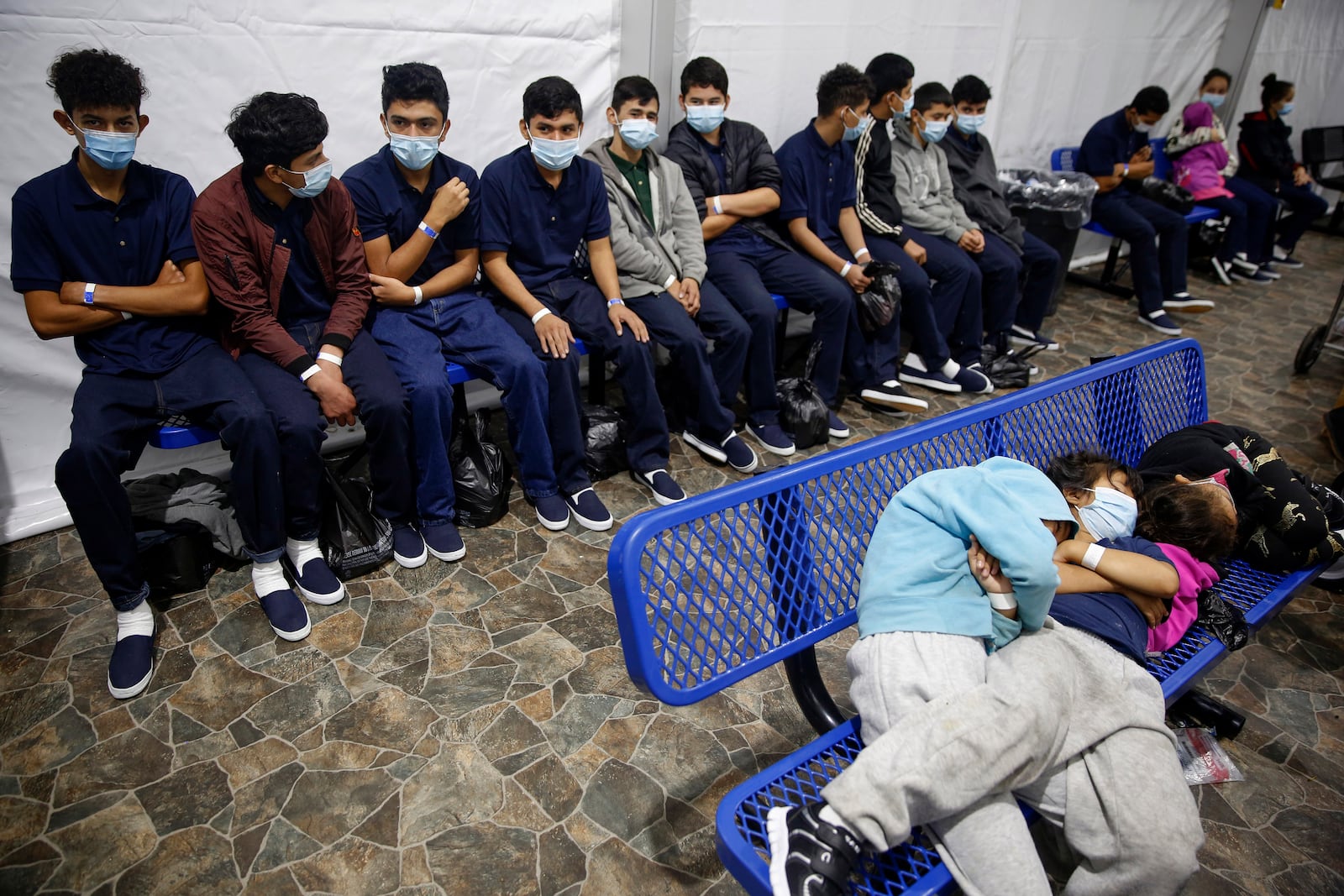 FILE - In this March 30, 2021, file photo, young unaccompanied migrants wait for their turn at the secondary processing station inside the U.S. Customs and Border Protection facility, the main detention center for unaccompanied children in the Rio Grande Valley, in Donna, Texas. (AP Photo/Dario Lopez-Mills, Pool, File)