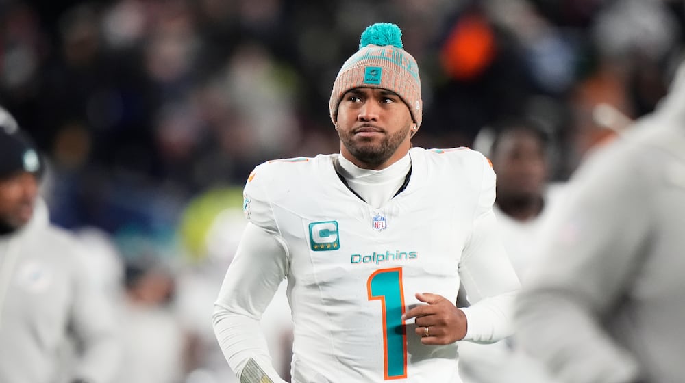 FILE - Miami Dolphins quarterback Tua Tagovailoa runs off the field during the first half of an NFL football game against the New England Patriots in Foxborough, Mass., Jan. 4, 2026. (AP Photo/Robert F. Bukaty, file)