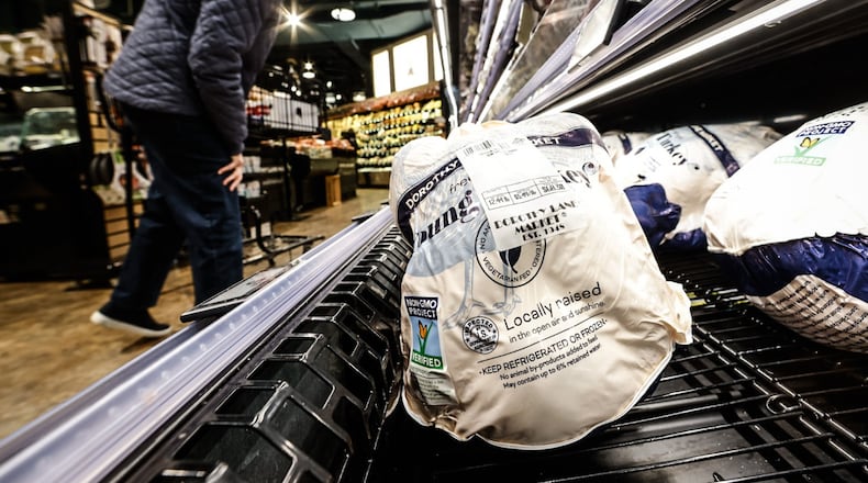 Shoppers peruse fresh turkeys at the Dorothy Lane Market in Oakwood Friday morning November 18, 2022. JIM NOELKER/STAFF