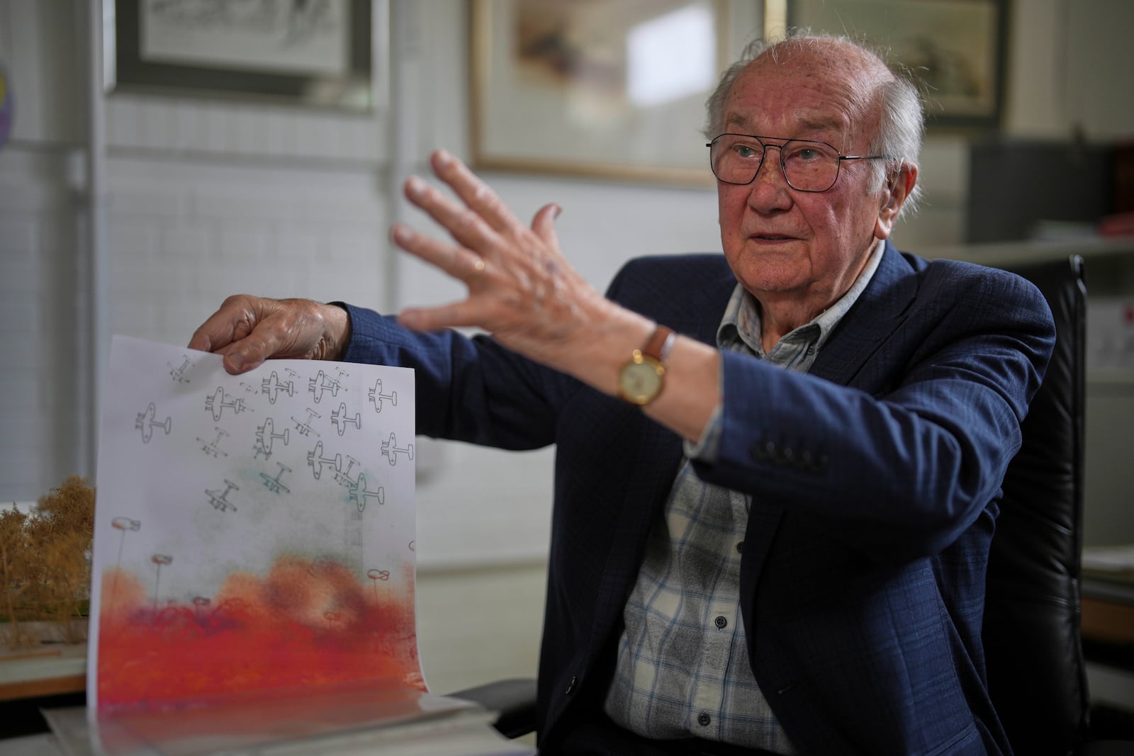 John Goldsmith, 94, shows his drawing during an interview at his home in London, Thursday, April 24, 2025. (AP Photo/Kin Cheung)