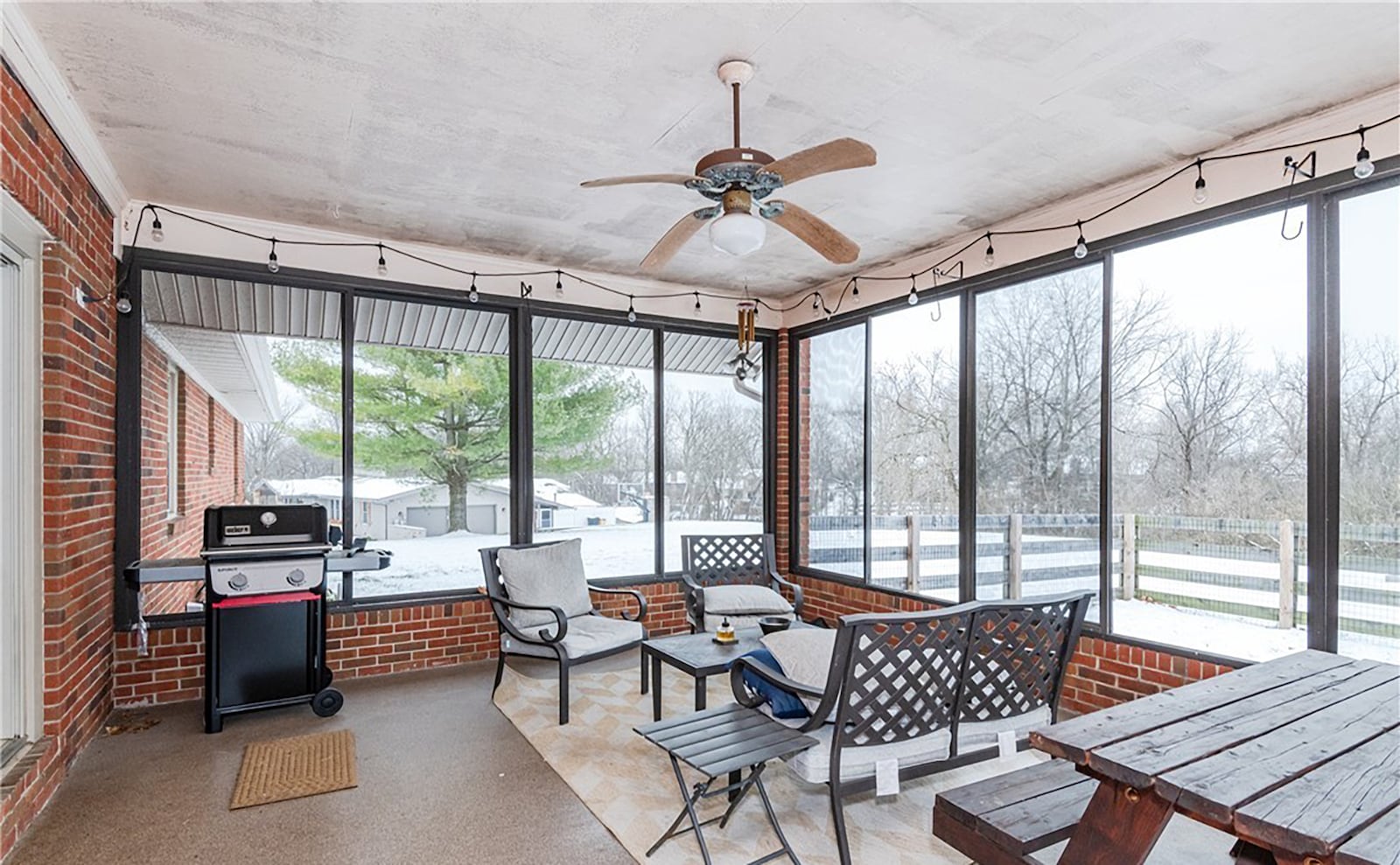 The screened in porch in the back yard has a concrete floor and ceiling fan and overlooks the partially fenced yard. CONTRIBUTED