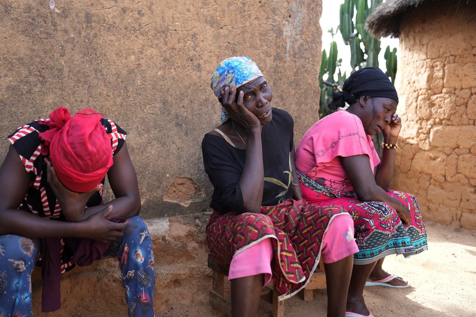 Women mourn the death of a family member following an attack by gunmen in the Zike farming community in north-central Nigeria, Tuesday, April 15, 2025. (AP Photo/Samson Omale)