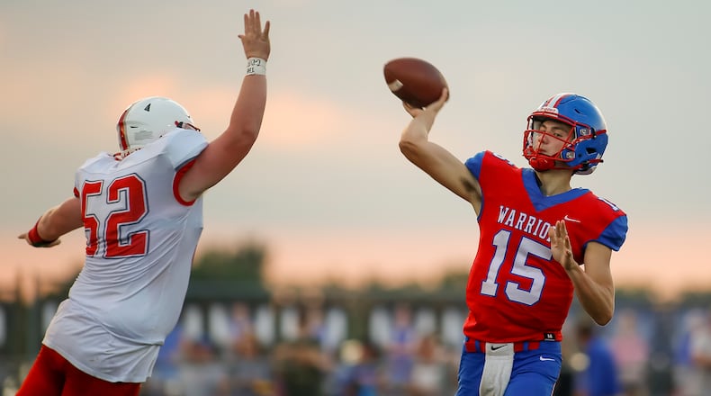 Northwestern High School junior quarterback Jacob Shaffer throws the ball in front Southeastern junior Andrew Flax during their Week 1 game last season in Springfield. Michael Cooper/CONTRIBUTED