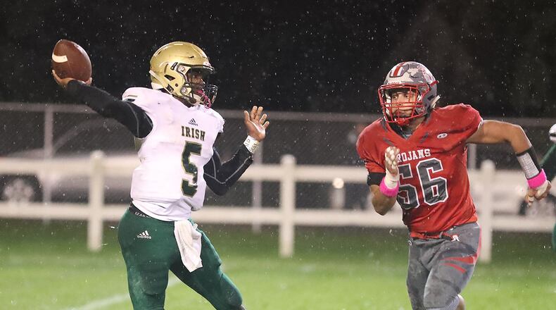 Catholic Central’s Jayden Borden throws the ball under pressure from Southeastern’s Jason Rutschilling. BILL LACKEY/STAFF