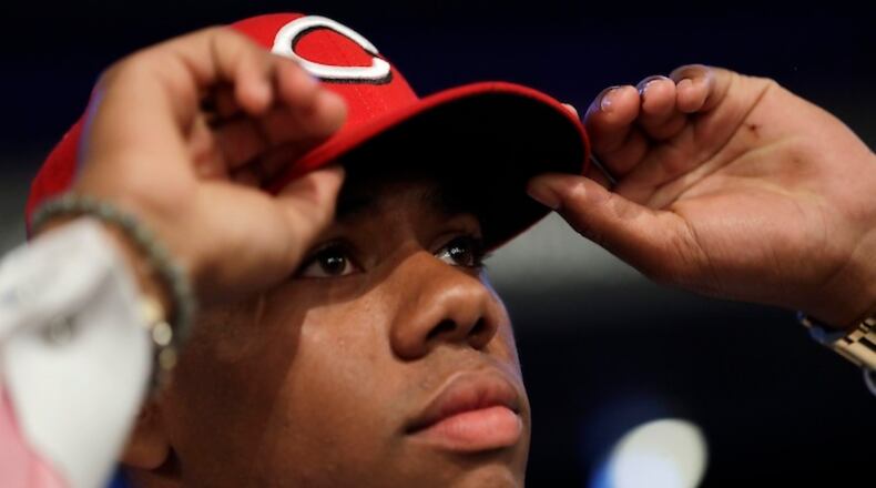 Hunter Greene, a pitcher and shortstop from Notre Dame High School in Sherman Oaks, Calif., adjusts his hat after being selected No. 2 by the Cincinnati Reds in the first round of the Major League Baseball draft, Monday, June 12, 2017, in Secaucus, N.J.(AP Photo/Julio Cortez)